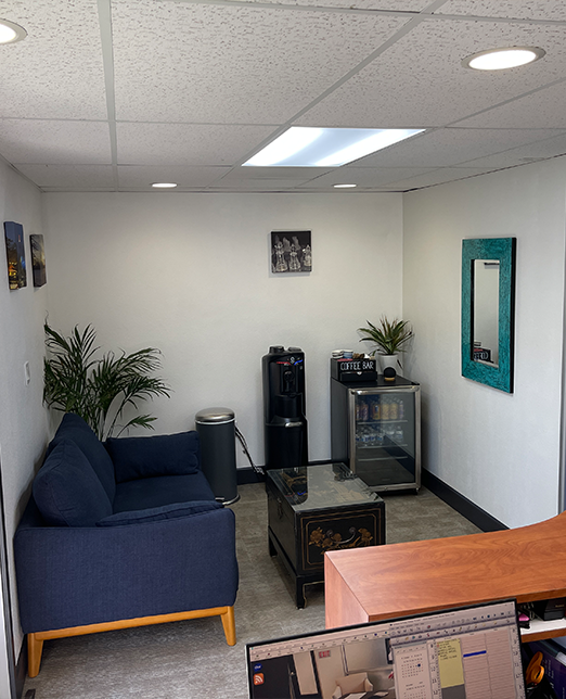 Blue chair, fridge, and other furniture in waiting room