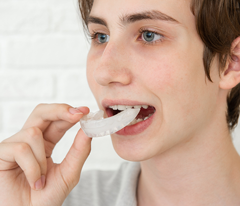 Boy opening mouth to put in nightguard